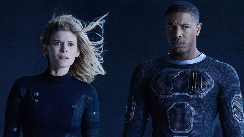 Kate Mara as Sue Storm stands next to Michael B. Jordan as Johnny Blaze in FAN4STIC
