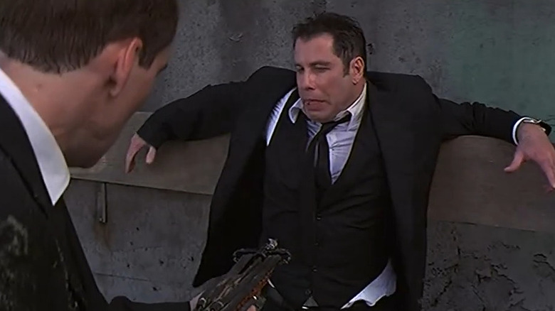 Sean Archer (Nic Cage) pointing a speargun at Castor Troy (John Travolta) in Face/Off