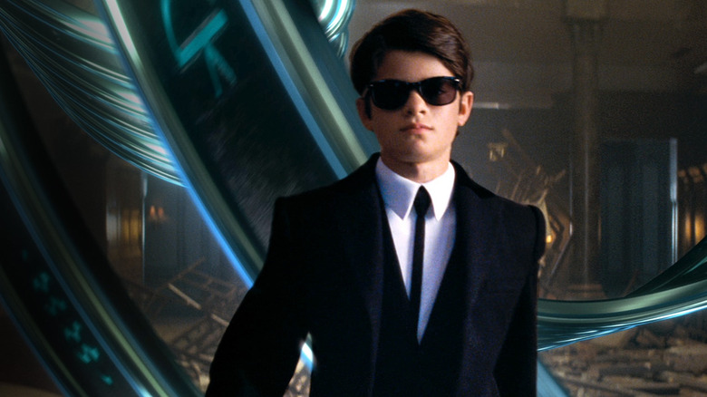 Artemis Fowl (Ferdia Shaw) struts in a suit in Artemis Fowl