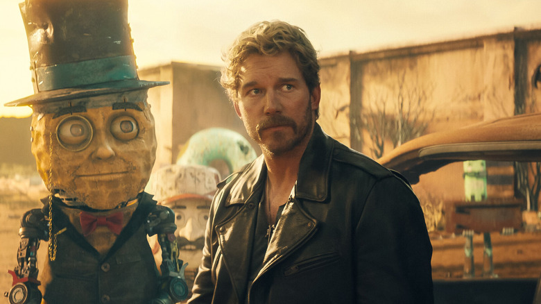Mr. Peanut (Woody Harrelson) and John D. Keats (Chris Pratt) look on ruefully on The Electric State