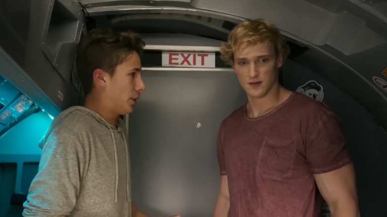 Juanpa Zurita and Logan Paul as themselves standing in an airplane cockpit with worried expressions in Airplane Mode