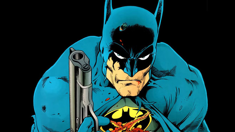 Batman holds a gun