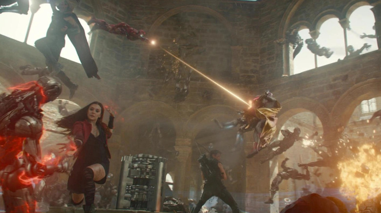 Chris Hemsworth as Thor, Elizabeth Olsen as Wanda, Iron Man, and Jeremy Renner as Hawkeye fighting Ultron bots in Avengers: Age of Ultron