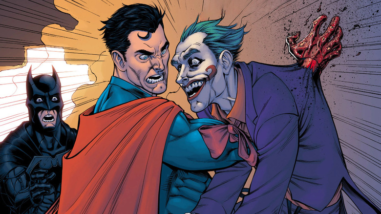 Superman impales the Joker with his arm as Batman watches