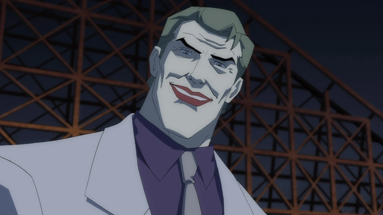 The Joker smiling at an amusement park in the film The Dark Knight Returns