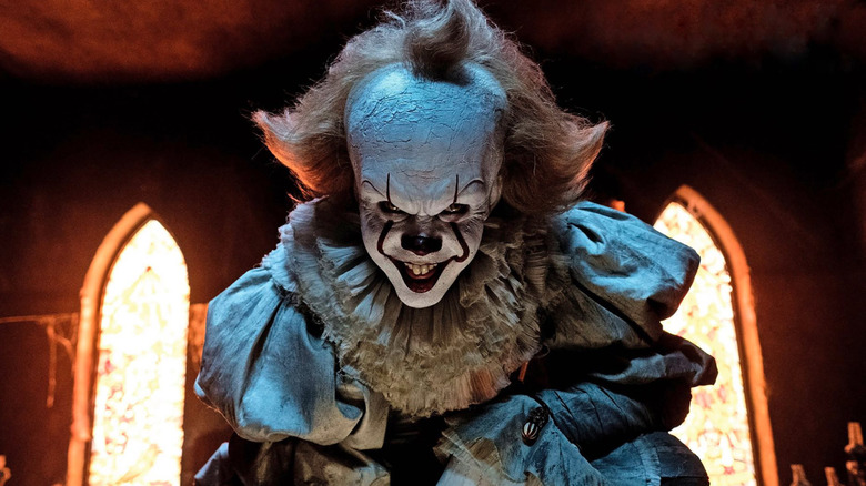 Pennywise menacingly looking into the camera in the movie "It"