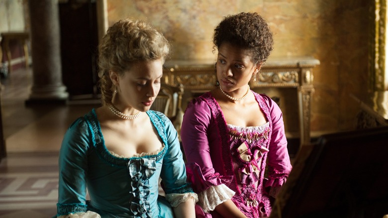 Two girls play piano in Belle