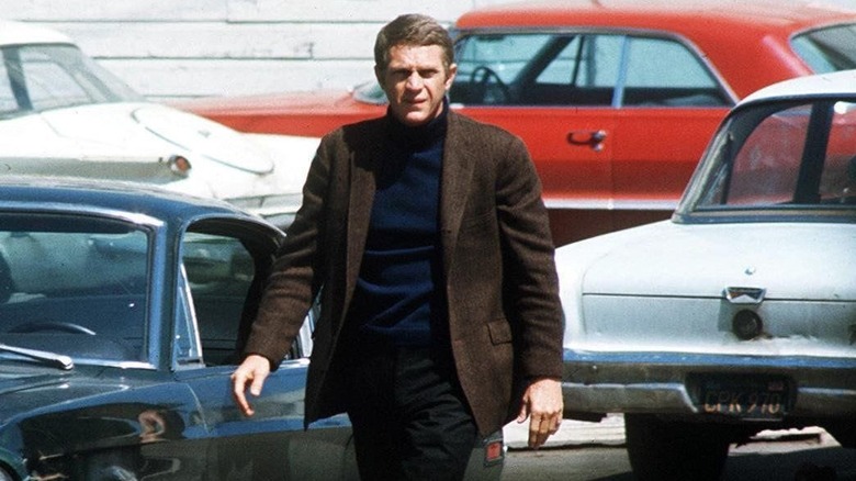 Steve McQueen walks in parking lot