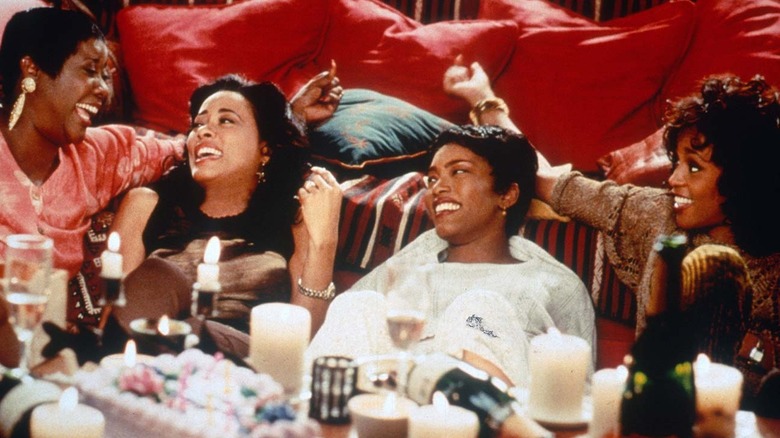 four women in living room laughing