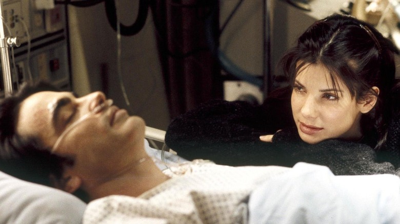 Sandra Bullock by unconscious Peter Gallagher