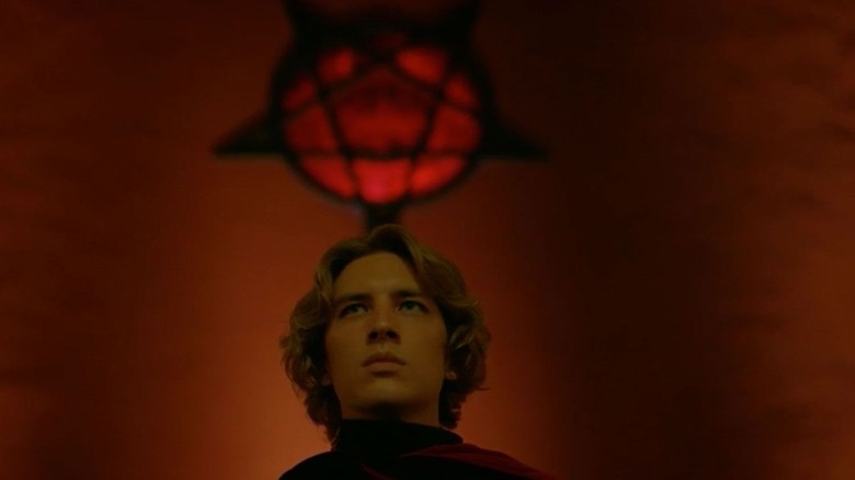 Michael stands beneath a pentagram