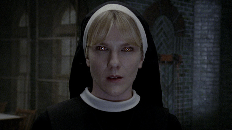 Sister Mary Eunice stares down the camera, her eyes turned yellow