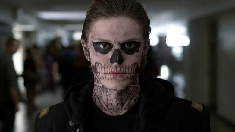 Tate stares down the camera, wearing skeleton makeup