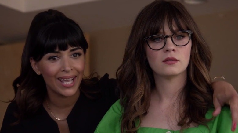Hannah Simone with arm around  Zooey Deschanel