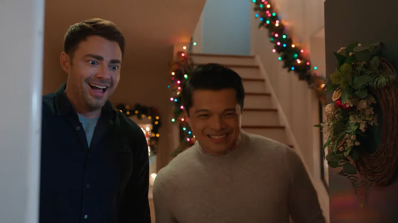 Mike and Zain (Jonathan Bennett and Vincent Rodriguez III) excited in doorway in Christmas on Cherry Lane