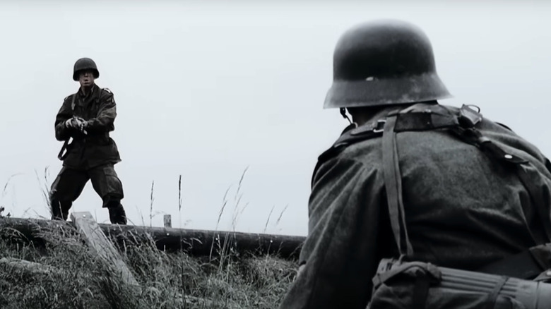 Richard D. Winters, aiming his gun at an enemy soldier in Band of Brothers