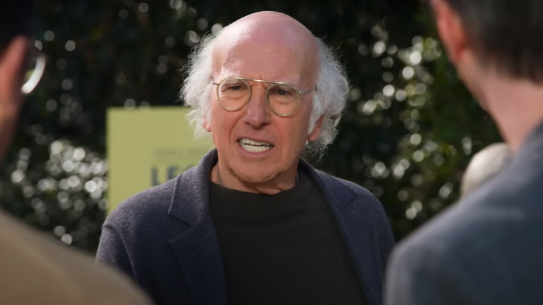 Larry David playing a fictional version of himself grimacing in Curb Your Enthusiasm