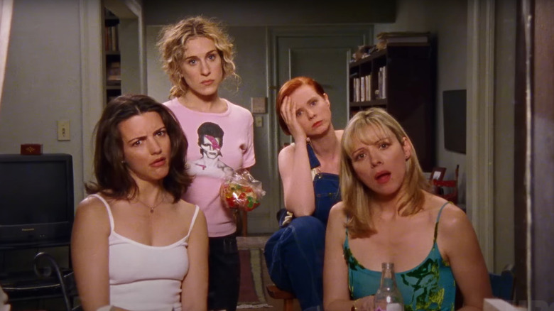 Carrie, Miranda, Charlotte, and Samantha looking out a window in the Sex and the City television series