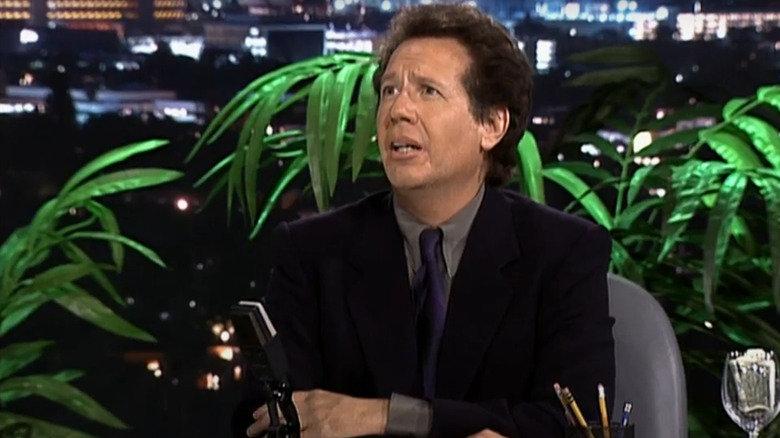Garry Shandling as Larry Sanders, looking up from his desk on the set of his talk-show on The Larry Sanders Show