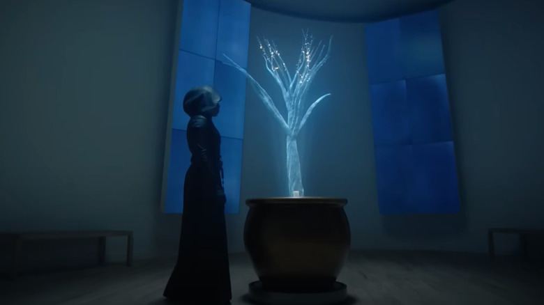 Sister Night, standing before a holographic tree on HBO's Watchmen television series