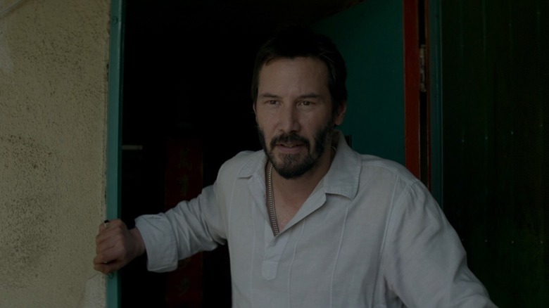 Keanu Reeves standing at door