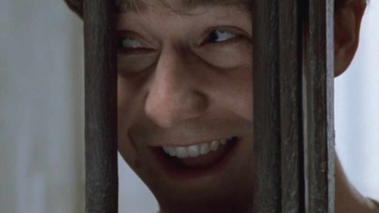 Edward Norton leers through jail bars.