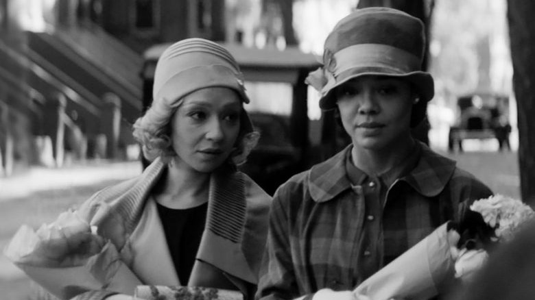 Ruth Negga and Tessa Thompson holding flowers