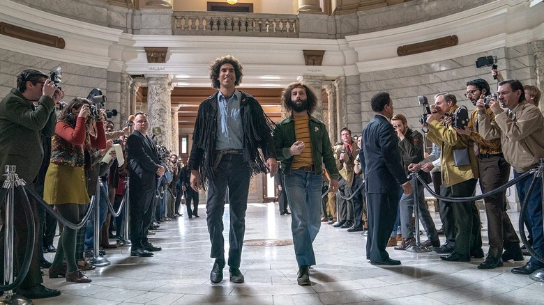 Sacha Baron Cohen and Jeremy Strong in court room