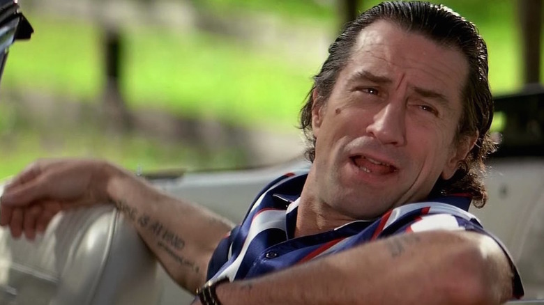 Tattooed Robert de Niro as Max Cady sitting in convertible in Cape Fear