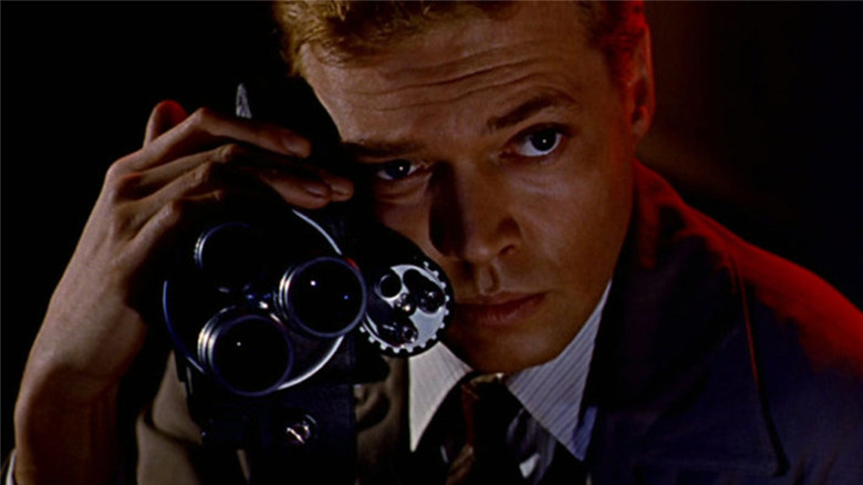Tom (Karlheinz Bohm) holding a camera in Peeping Tom