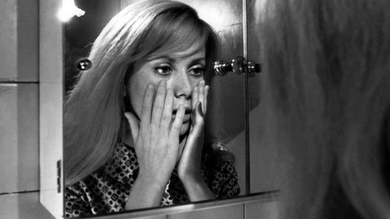 Catherine Denuve looking at herself in the mirror in Repulsion
