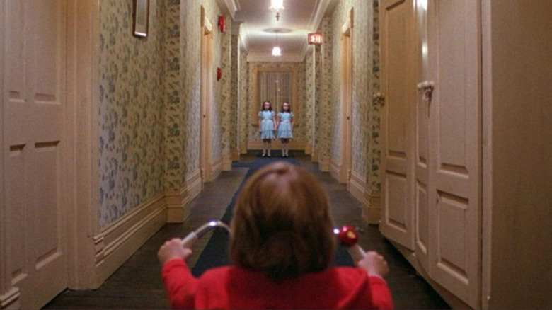 Danny looking at the twins down the hall in The Shining