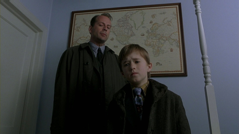 Bruce Willis and Haley Joel Osment stare off-screen in The Sixth Sense