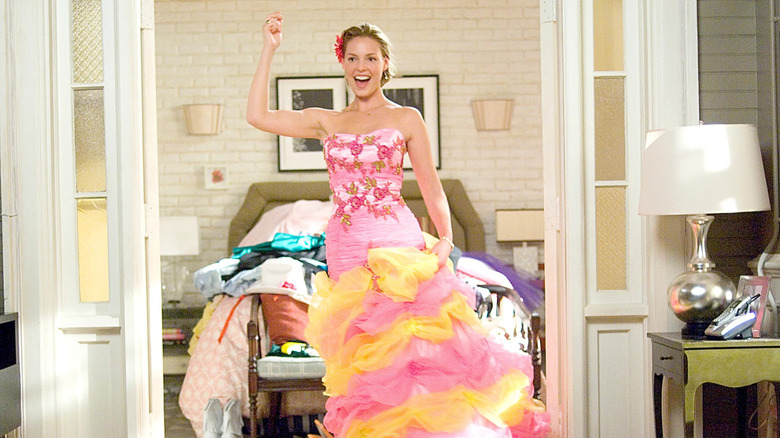 Jane Nichols trying on a puffy, pink, and yellow bridesmaids dress.