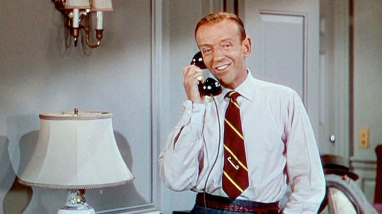 Tom Bowen smiles as he speaks on the telephone.