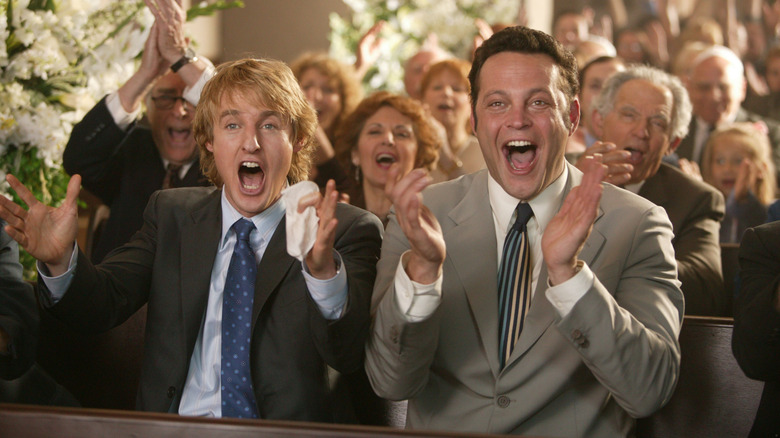 John and Jeremy cheer happily at a wedding.