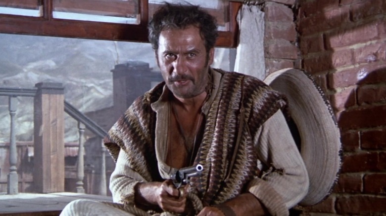 Eli Wallach holds gun