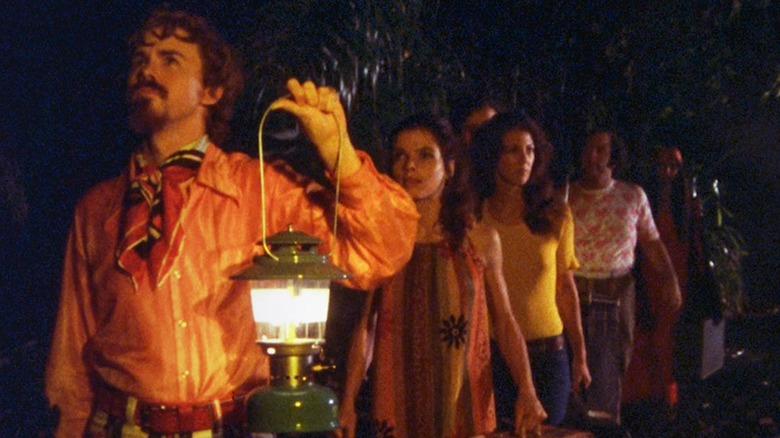 Troupe in the woods with lanterns