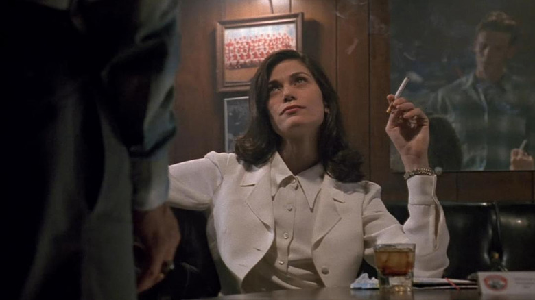 Linda Fiorentino as Bridget Gregory smoking a cigarette in a bar in The Last Seduction