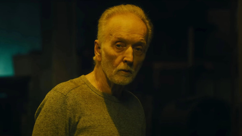 Tobin Bell as John Kramer, sulking through a warehouse in Saw X