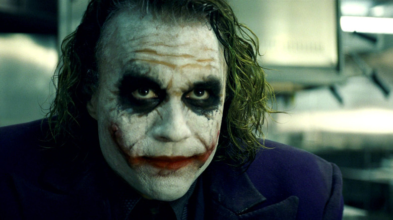 Heath Ledger as The Joker, walking down the street in The Dark Knight