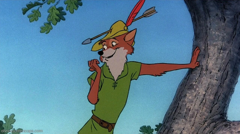 Robin leans on a tree while an arrow sticks through his hat in Robin Hood