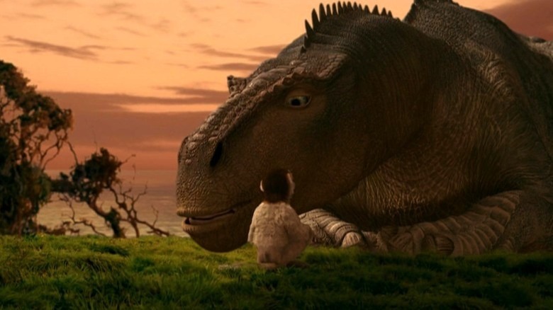 Plio sitting in front of a lying Aladar in Dinosaur