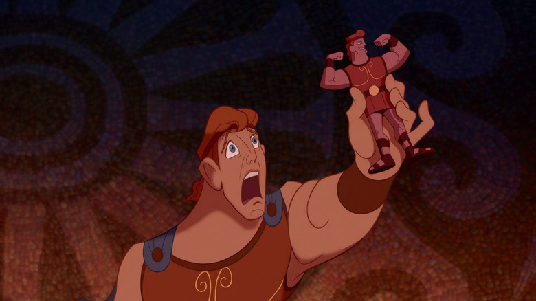Hercules looks shocked, holding an action figure of himself