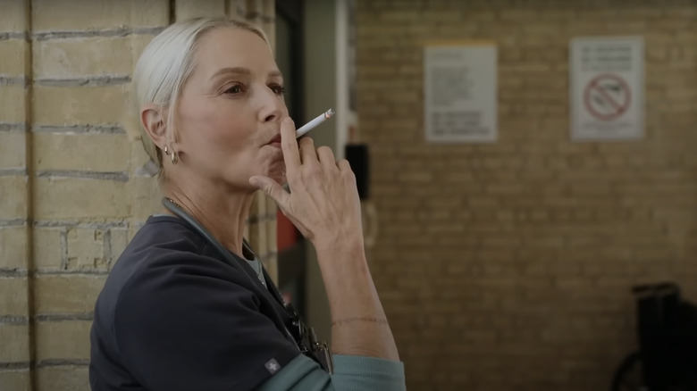 Katherin LaNasa's Dana Evans smokes a cigarette outside the hospital in The Pitt