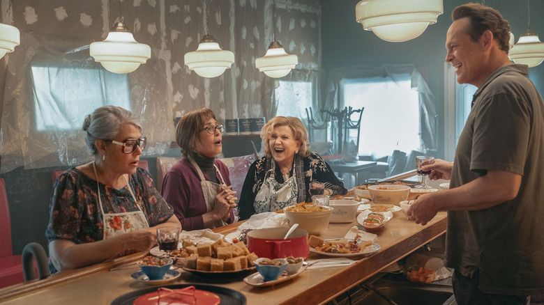 Lorraine Bracco as Roberta, Talia Shire as Teresa, and Brenda Vaccaro as Antonella sitting at a countertop in front of Vince Vaughn as Joe Scaravella in Nonnas