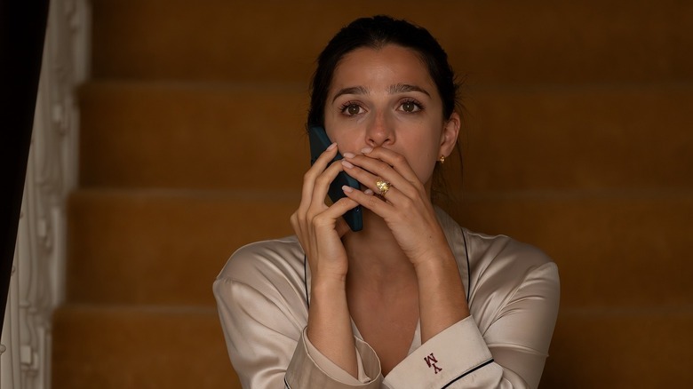 Yasmin with her hand on her mouth shocked on the phone on Industry