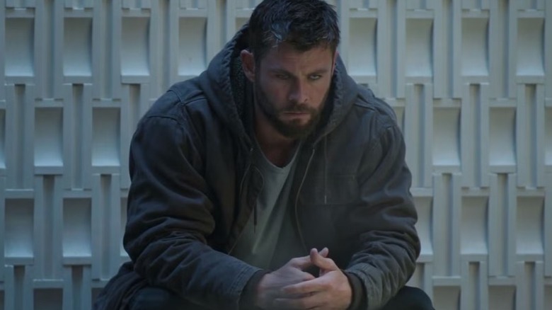 Thor sitting down and looking sad in 