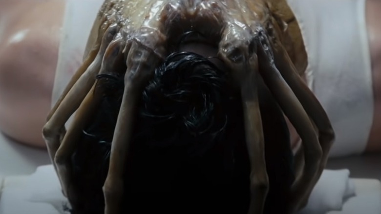 prone figure facehugger