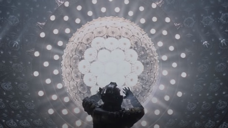 Figure in spacesuit glowing orb